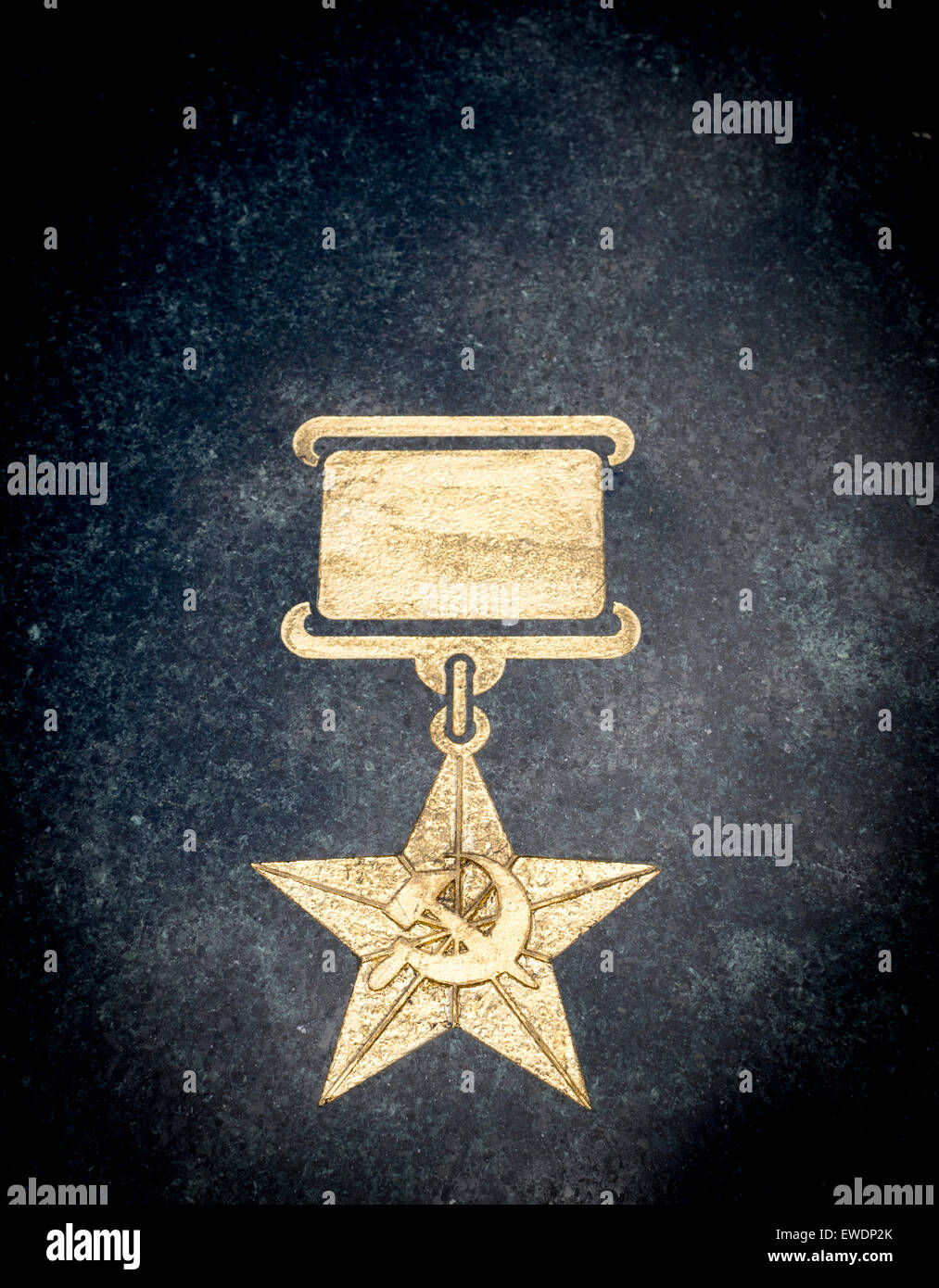 Single soviet star in gold paint on a marble stone background Stock Photo