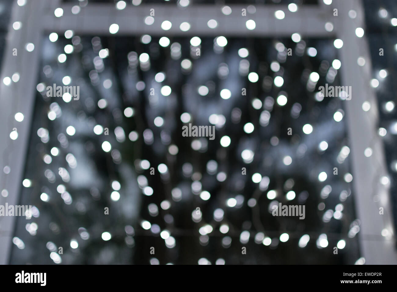Many blurred white celebration fairy lights create abstract patterns Stock Photo