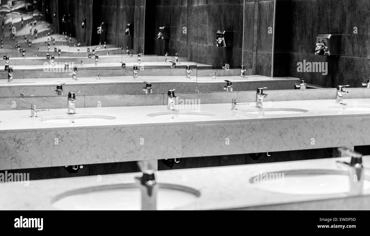 Black and white image of bathroom mirrors reaching into infinity Stock Photo