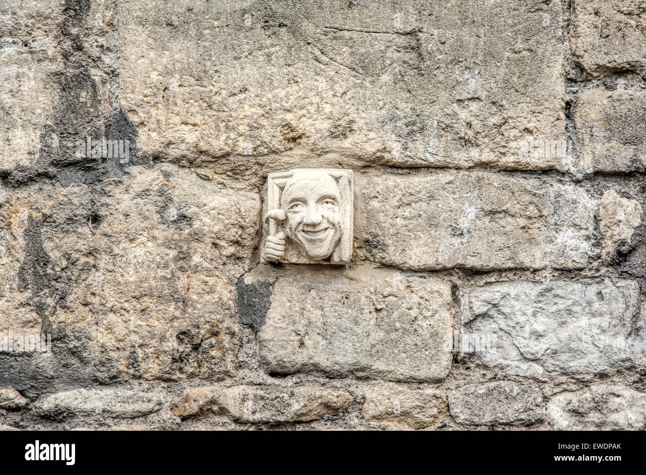 Hand carved Bath stone face on a wall in Walcot Street Bath one of more