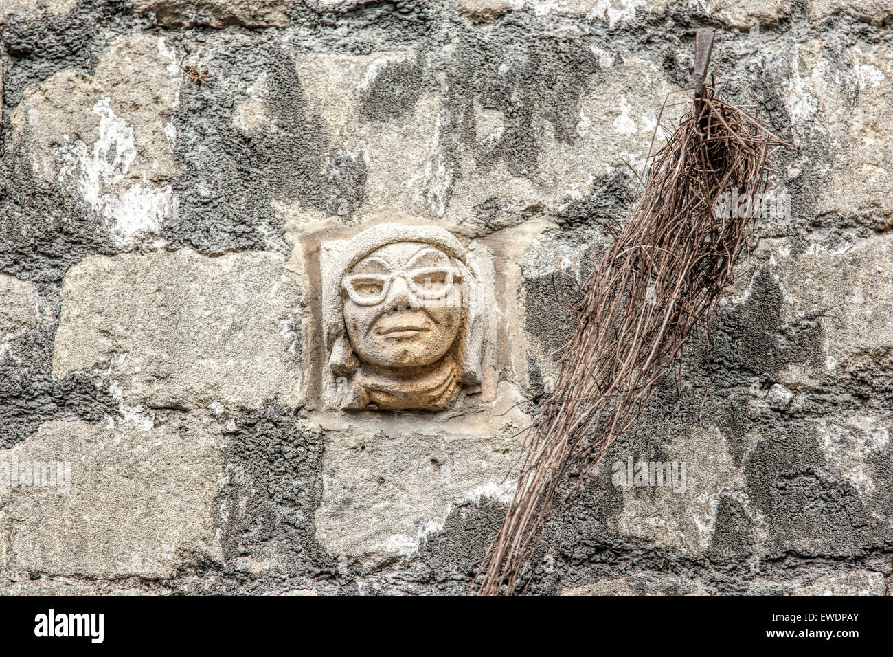 Stone face hand carved in Bath Stone on a wall in Walcot Street Bath Stock Photo