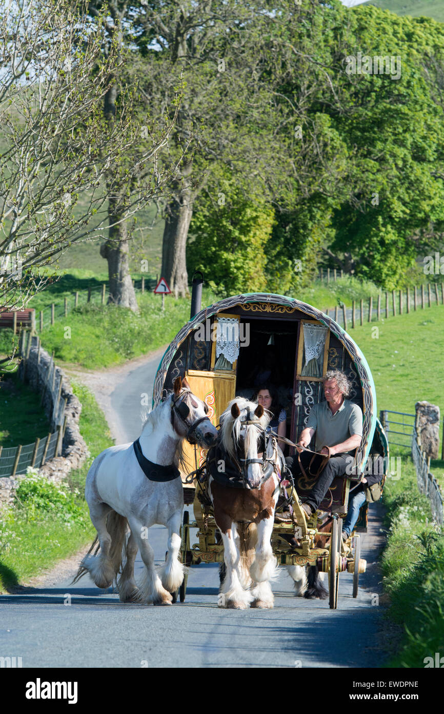 Horse drawn caravans heading along a narrow rural road near Kirkby ...