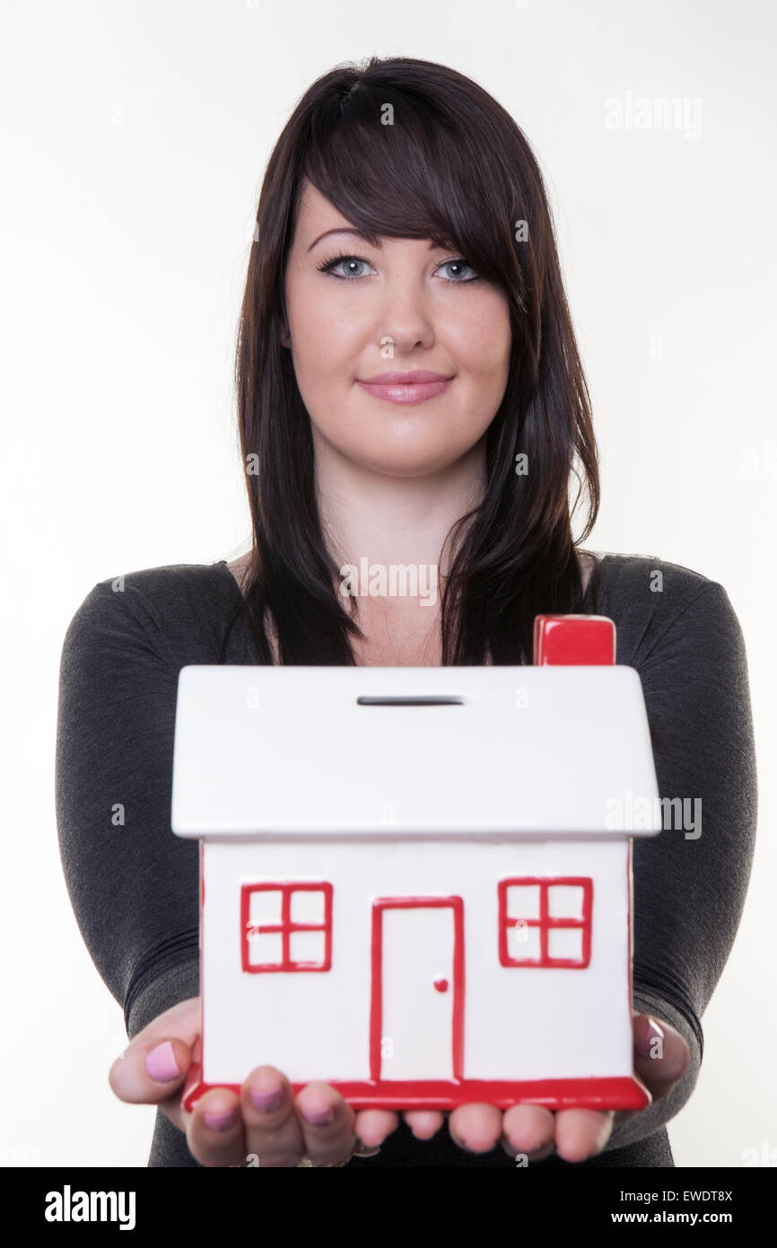 woman holding a money box in the shape of a house Stock Photo Alamy