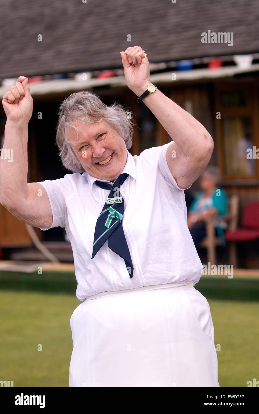 Elderly president of a local bowls club in jubilant mood at the clubs' 80th birthday celebrations, Frensham, Surrey, UK. Stock Photo