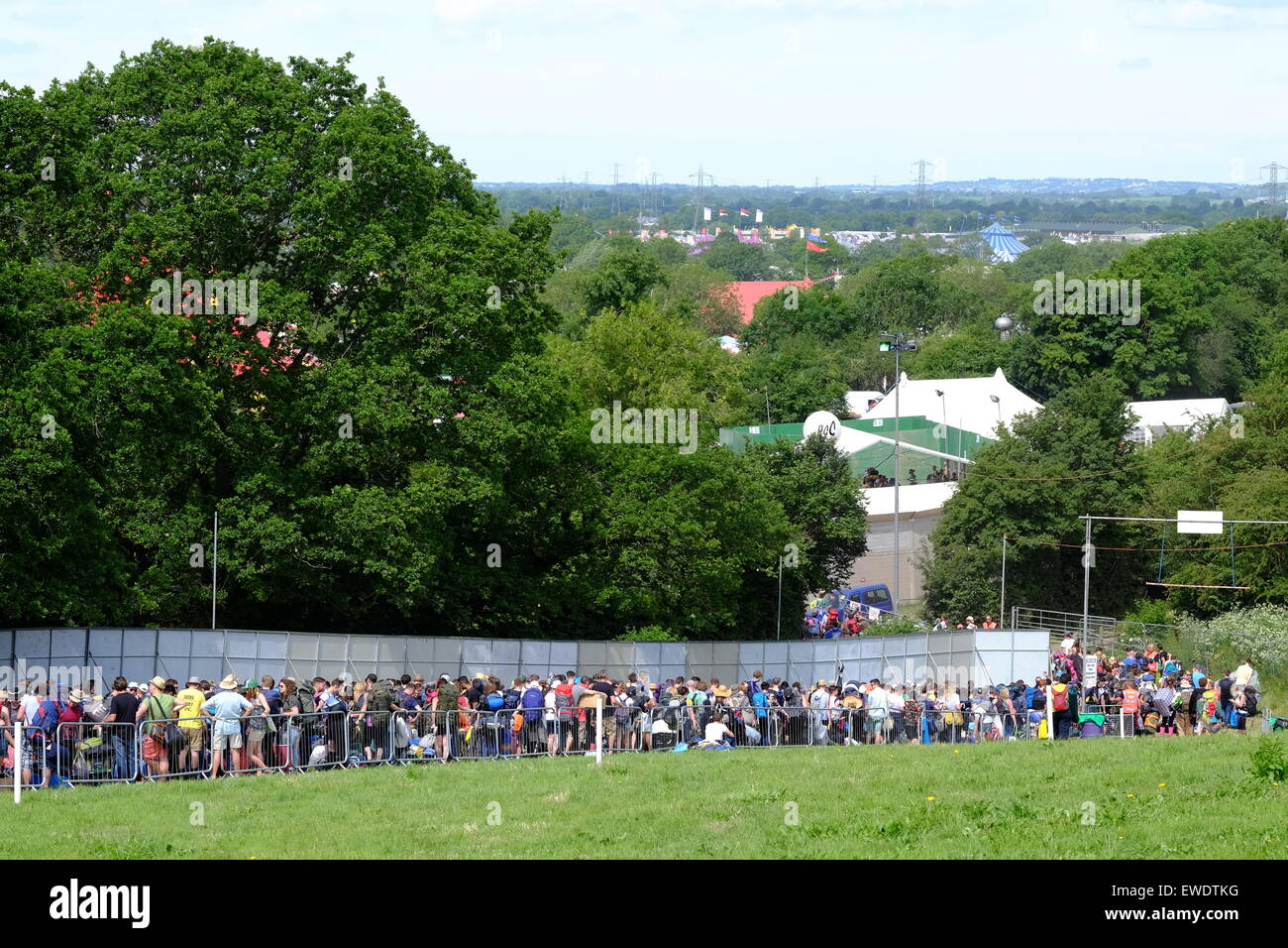 Glastonbury Festival, Somerset, UK. 24 June 2015. Festival goers wait patiently as more crowds arrive at the  2015 Glastonbury Festival and queues build up at the gates as people wait to pass through the strict controls at  the festival gates. Credit:  Tom Corban/Alamy Live News Stock Photo