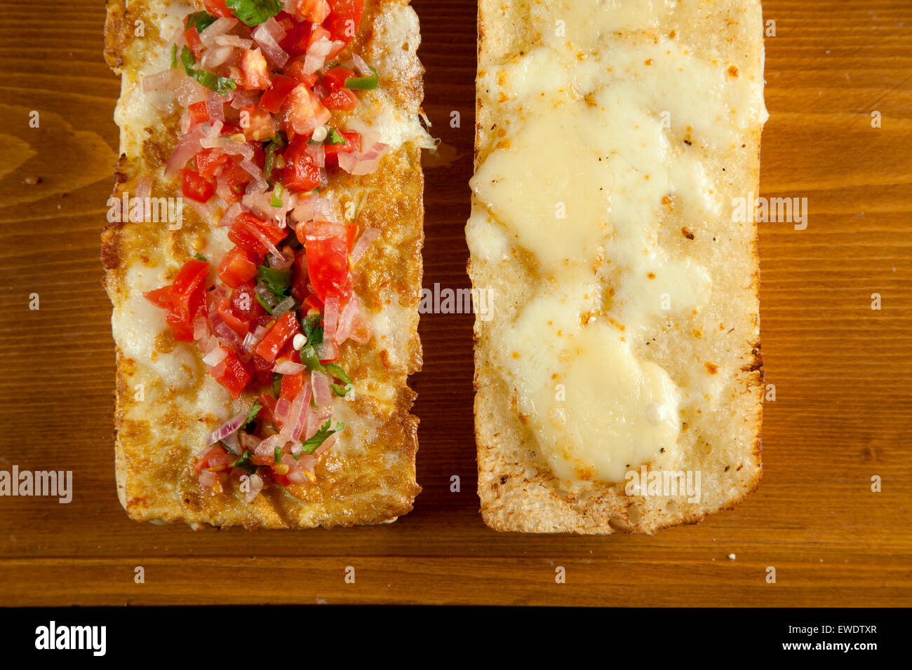 Toasted open faced salsa and egg sandwich with melted mozzarella cheese