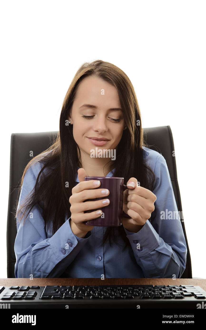 business woman sitting at her desk drinking tea Stock Photo - Alamy