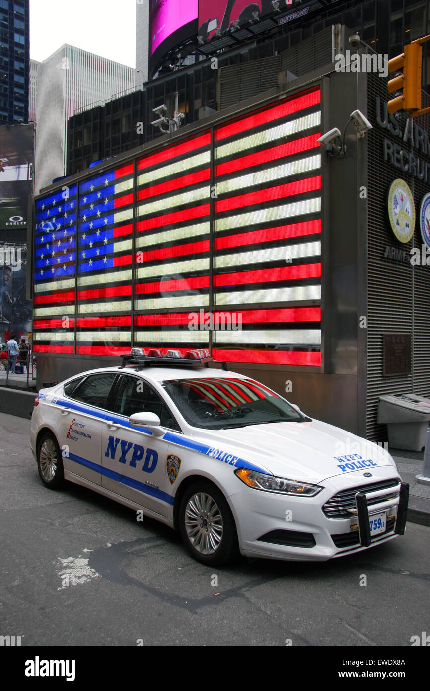 NYPD car by large American flag, Times Square, Manhattan, New York City, USA Stock Photo