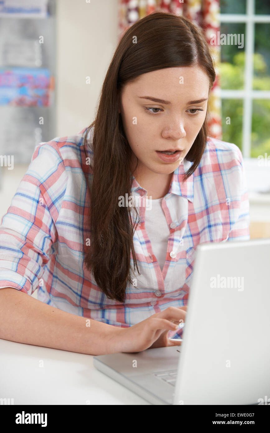 Teenage Girl Victim Of Online Bullying With Laptop Stock Photo
