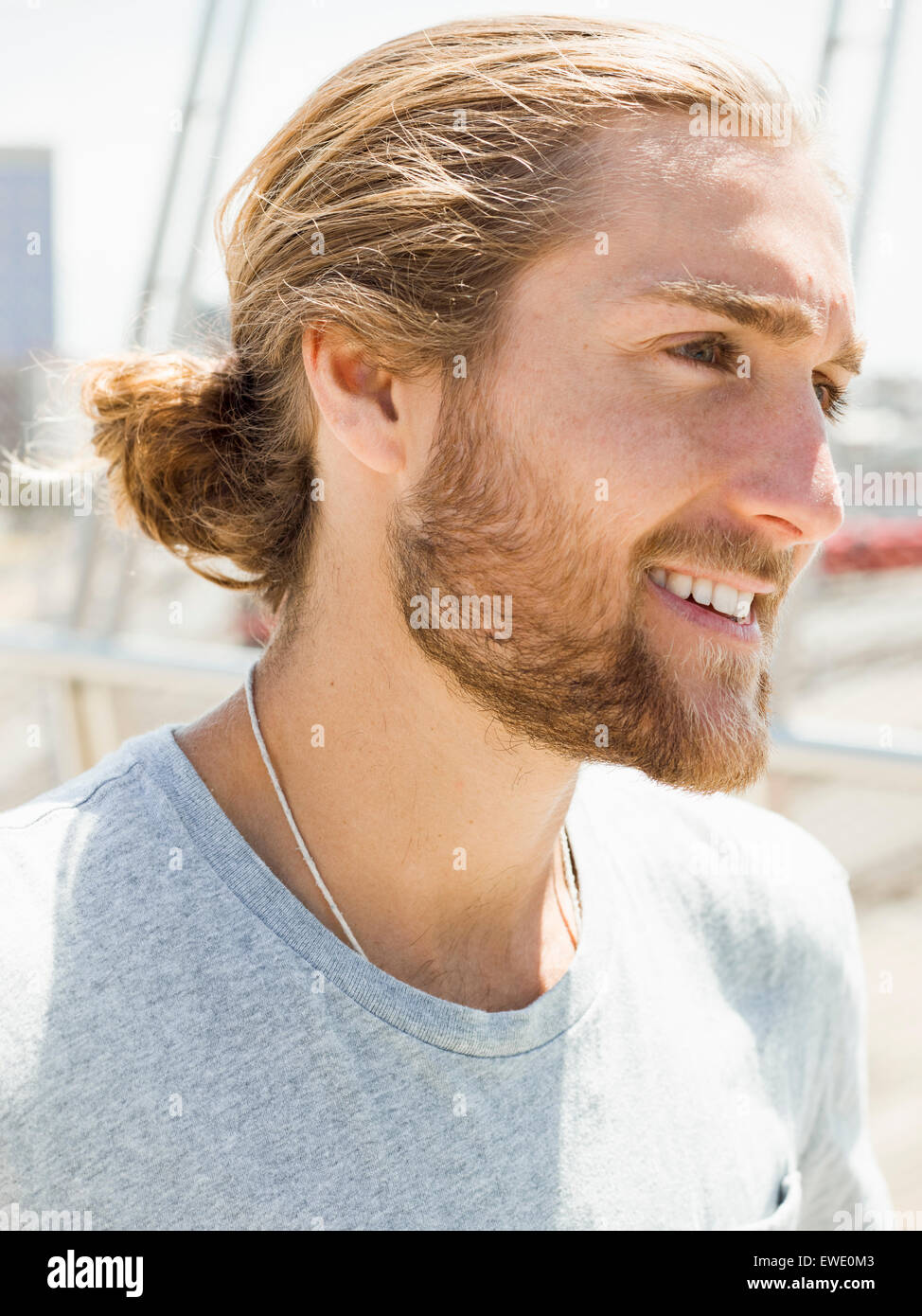 A young man with beard, red hair and ponytail Stock Photo