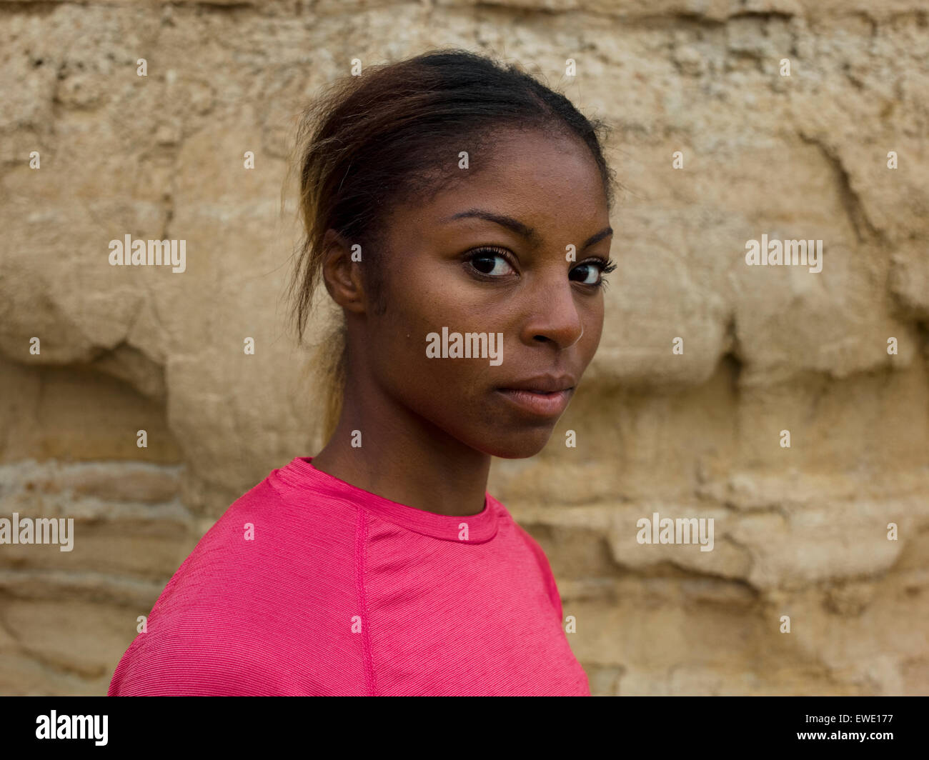 An apprehensive young woman looking sideways Stock Photo