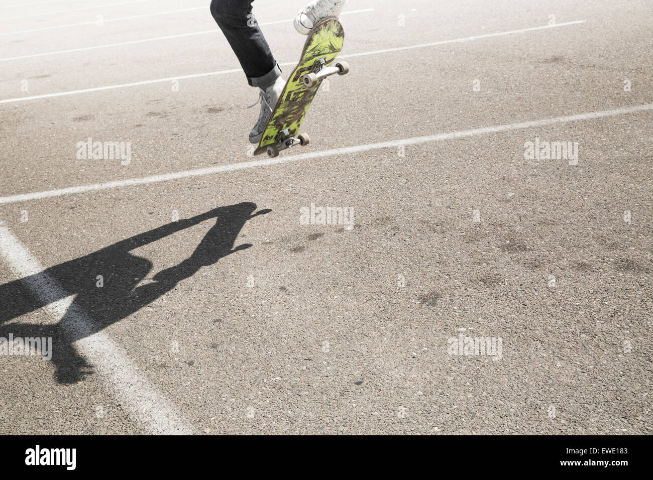 Young man skateboarding in a car park urban city life Stock Photo