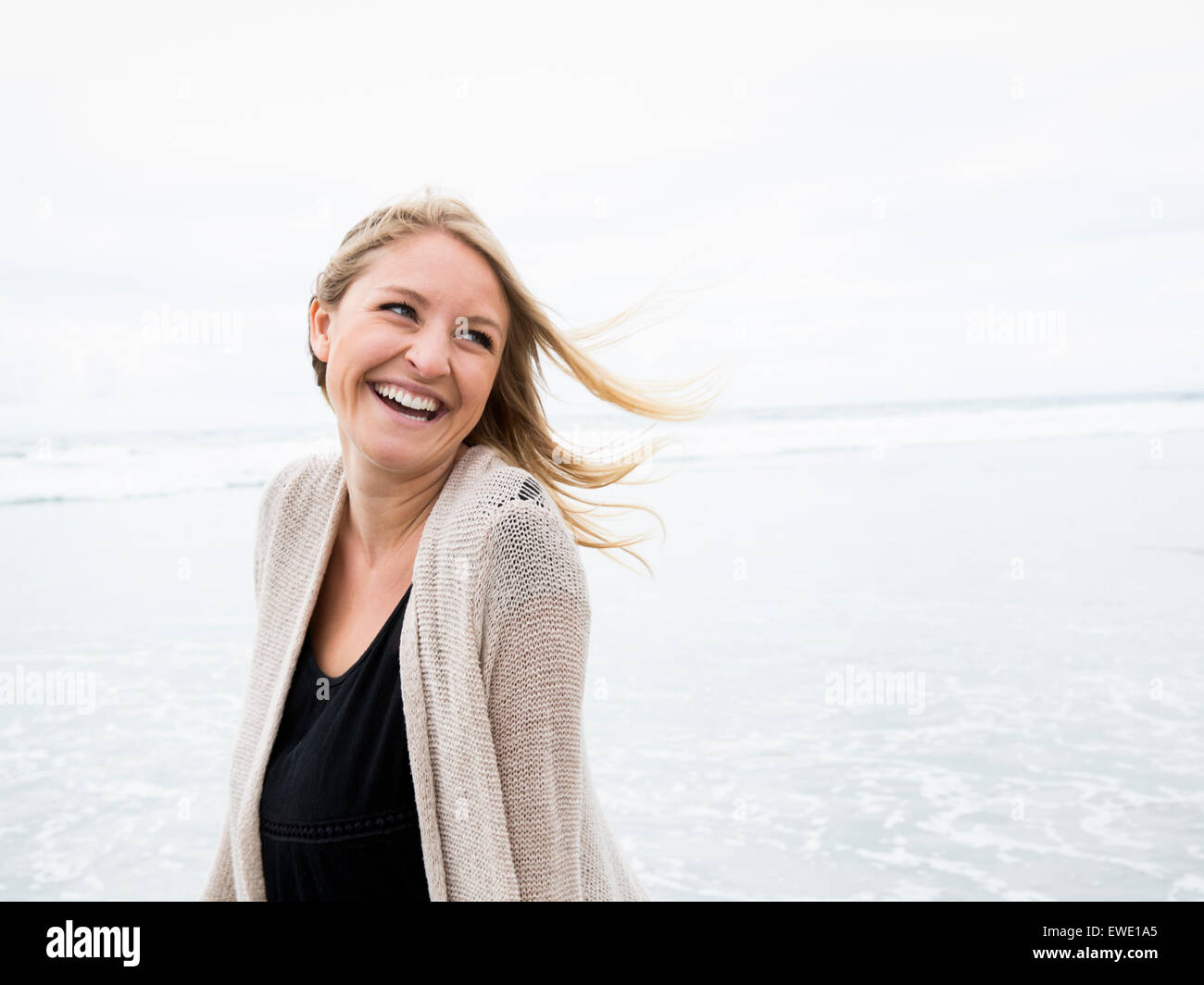 Portrait of a smiling young woman on a beach Stock Photo - Alamy