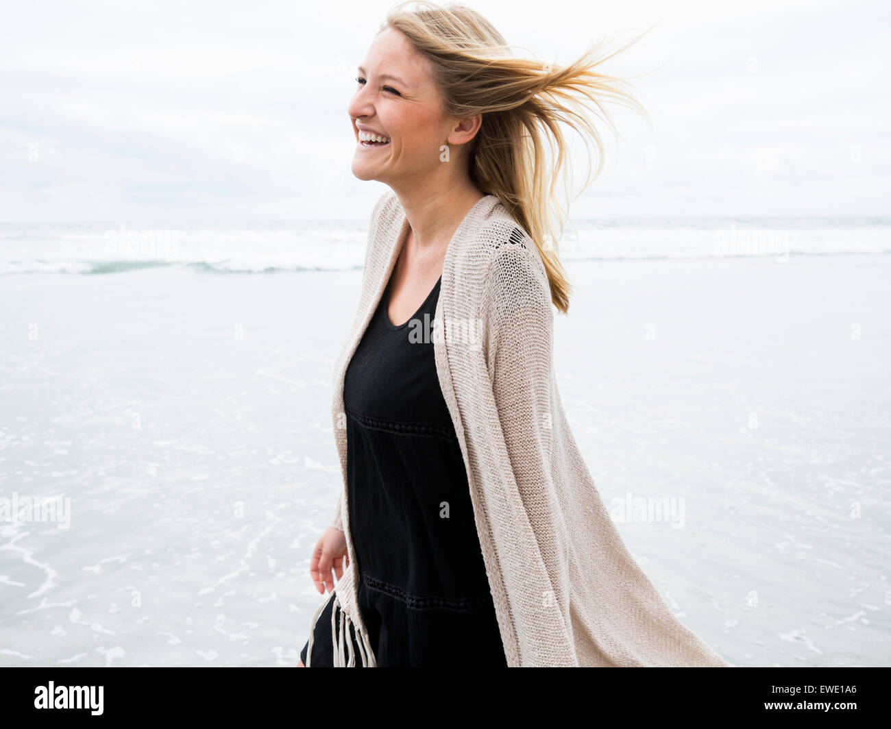 Portrait of a smiling young woman on a beach Stock Photo - Alamy