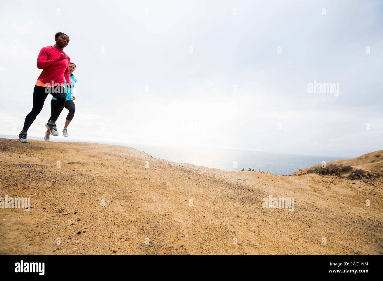 Two women jogging along the coast fitness Stock Photo