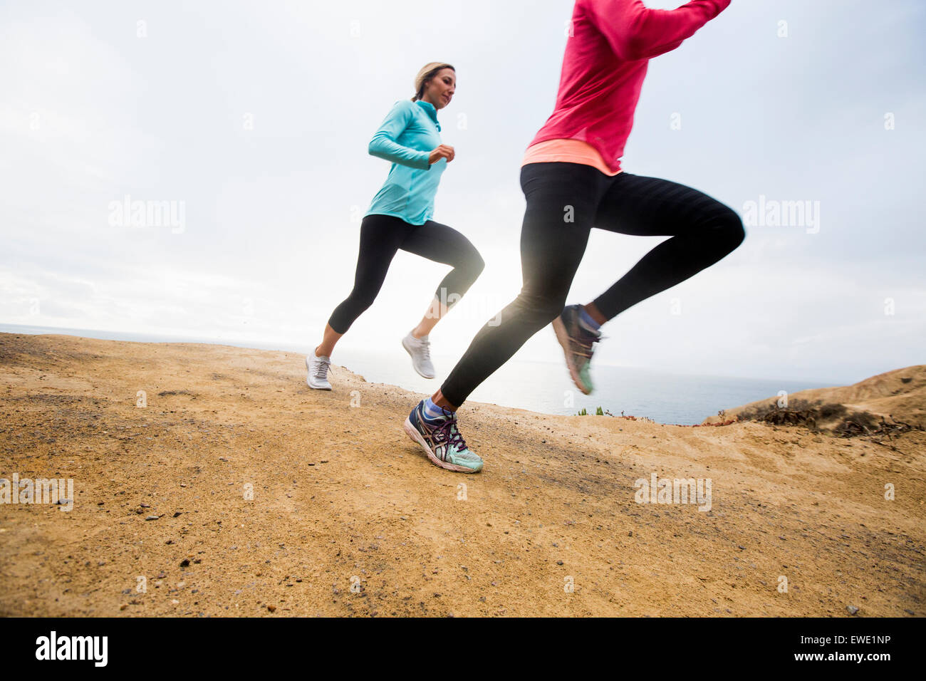 Two women jogging along the coast runner Stock Photo