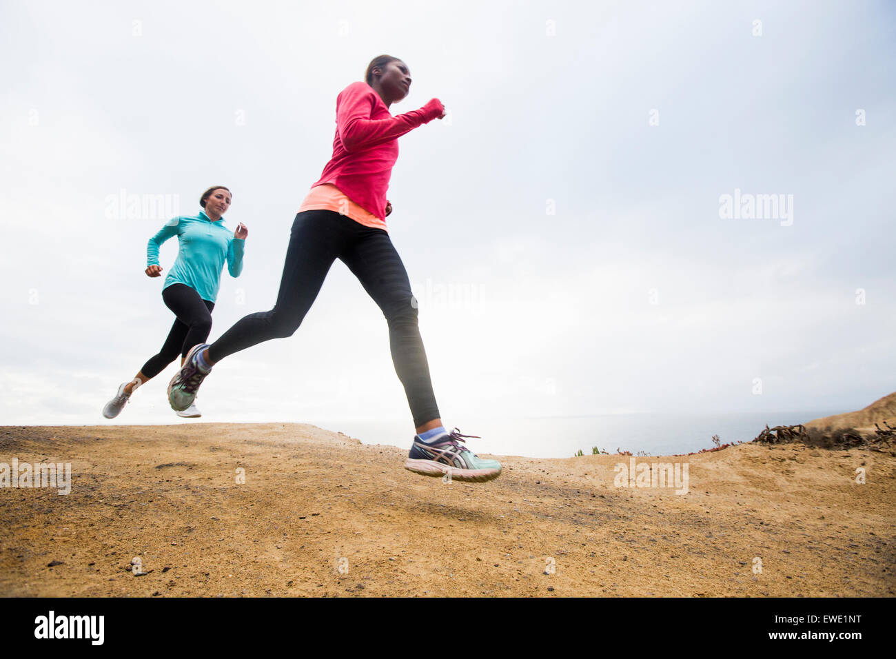 Two women jogging along the coast fitness Stock Photo