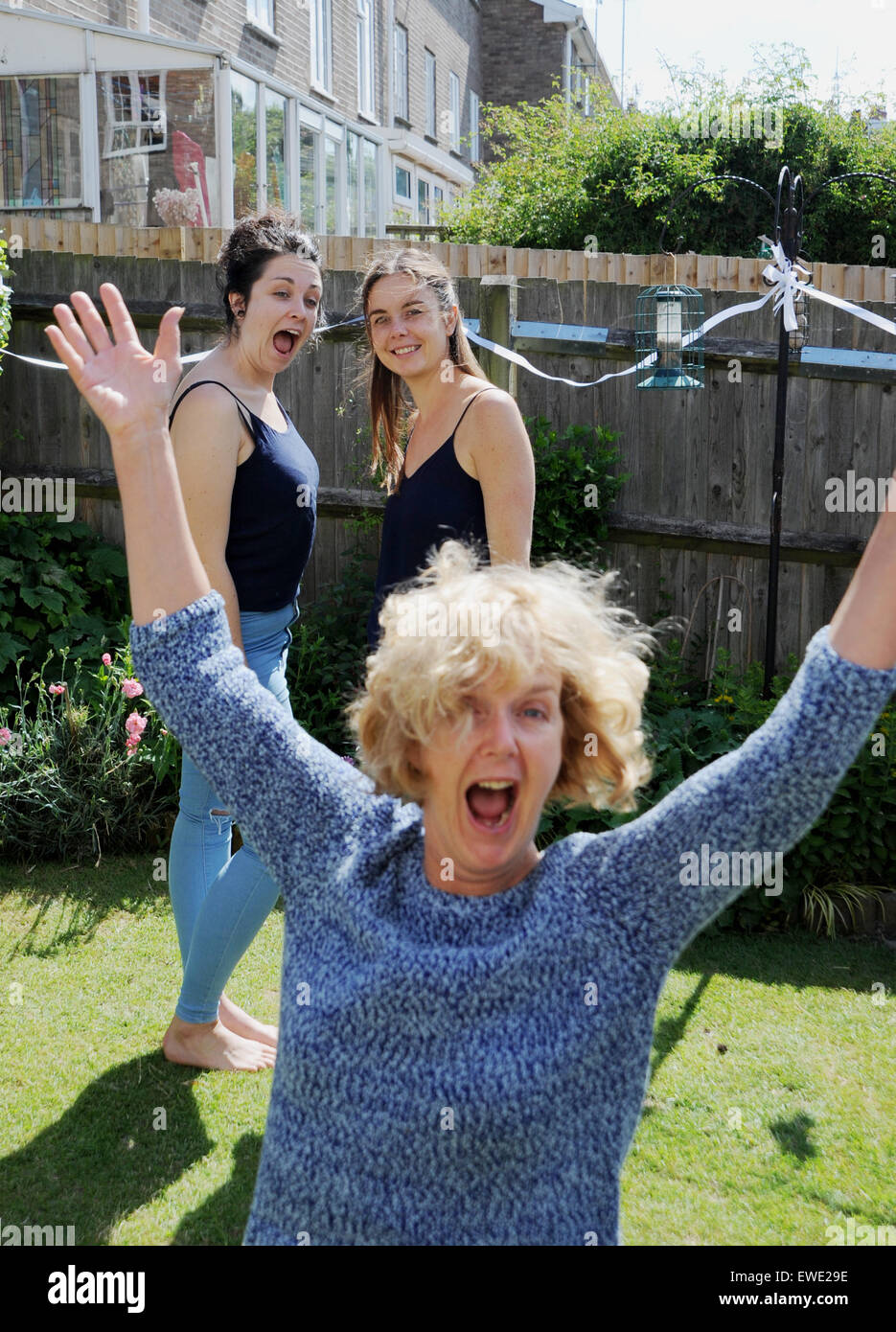 Older Mature Woman Photo Bombs Two Younger Women Having Fun Stock