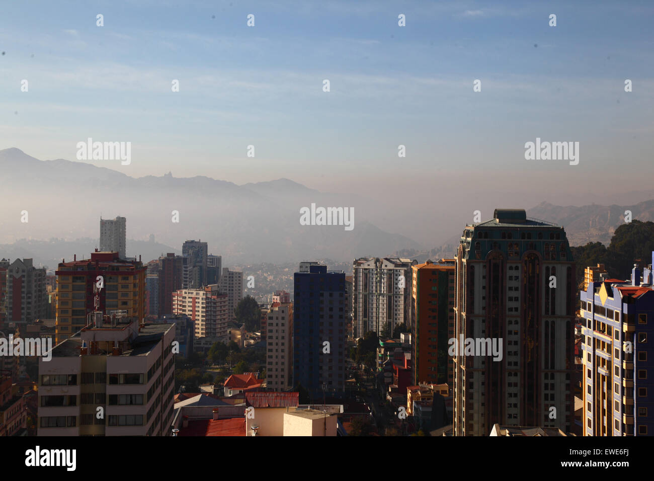 La Paz, Bolivia, 24th June 2015. Smoke fills the valleys of the lower part of La Paz shortly after sunrise after San Juan night. San Juan is traditionally believed to be the coldest part of the year and many people in Bolivia light bonfires and set off fireworks. Local authorities have been attempting to stop this custom in the last few years to reduce the extra pollution it causes in the city, but with only limited success. Stock Photo