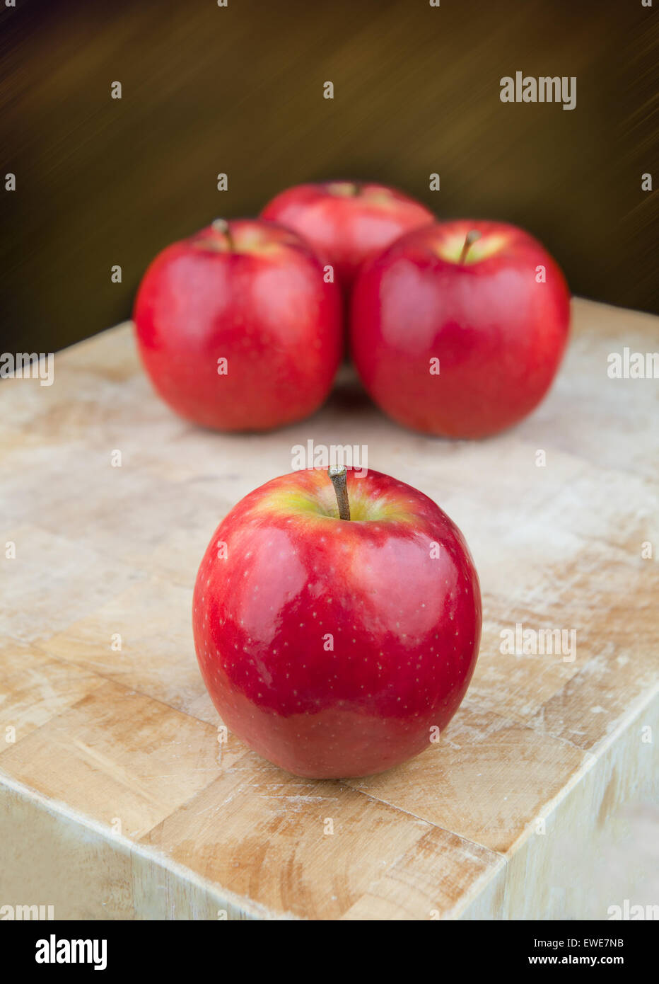 Red apples on chopping board. Stock Photo