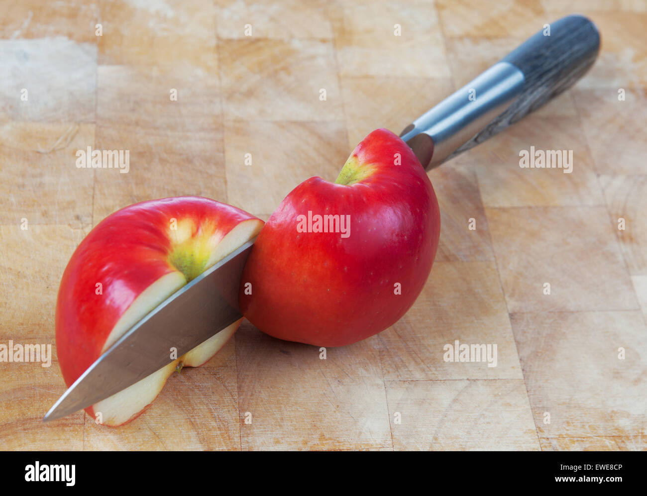 Knife cutting an apple on chopping board Stock Photo Alamy