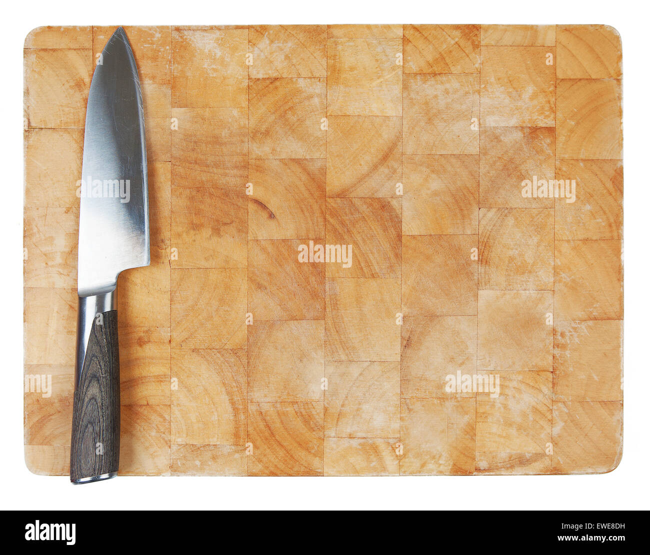 Kitchen knife laying on used chopping board. Stock Photo