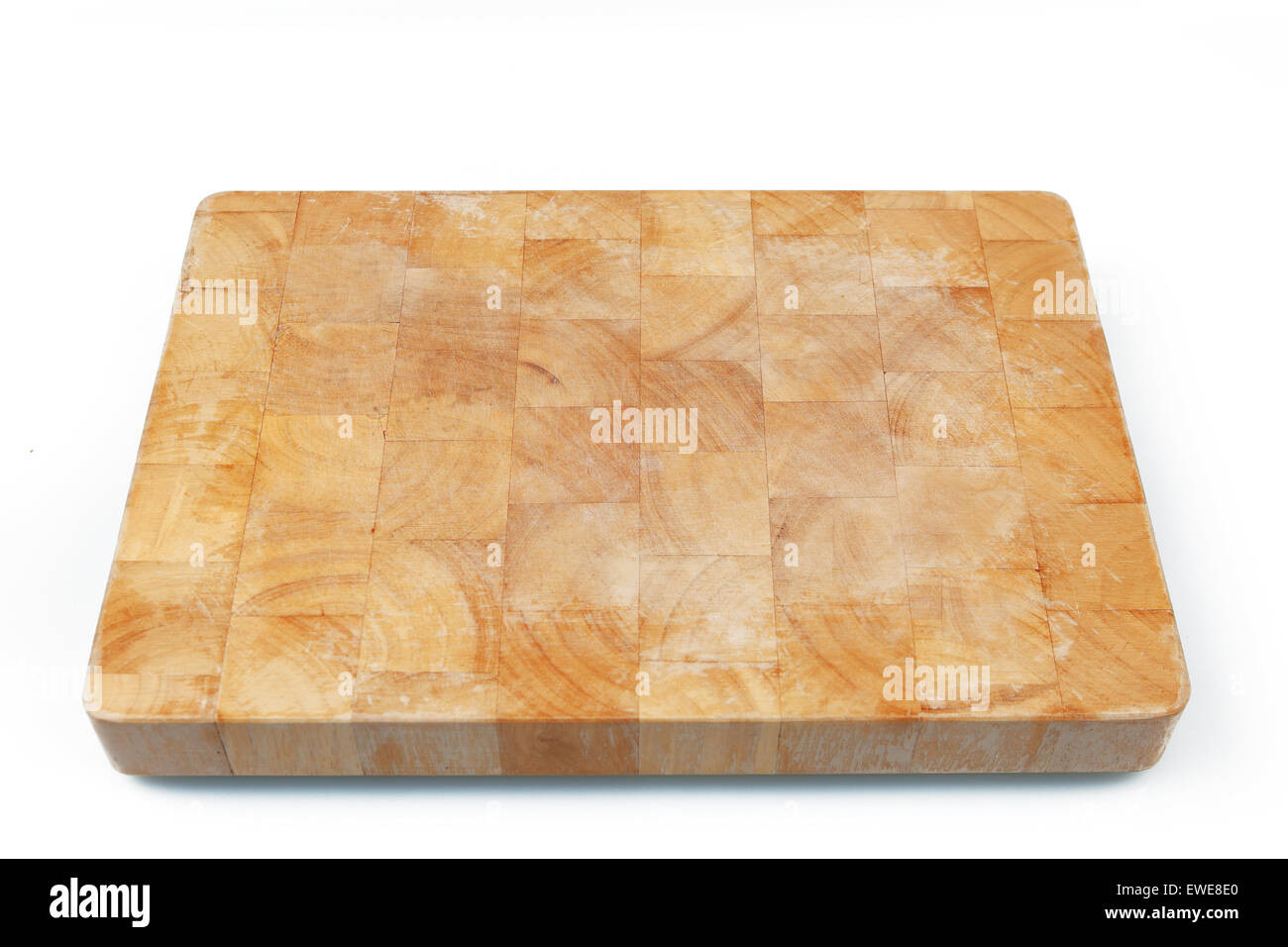 Wooden used cutting board on white background. Stock Photo