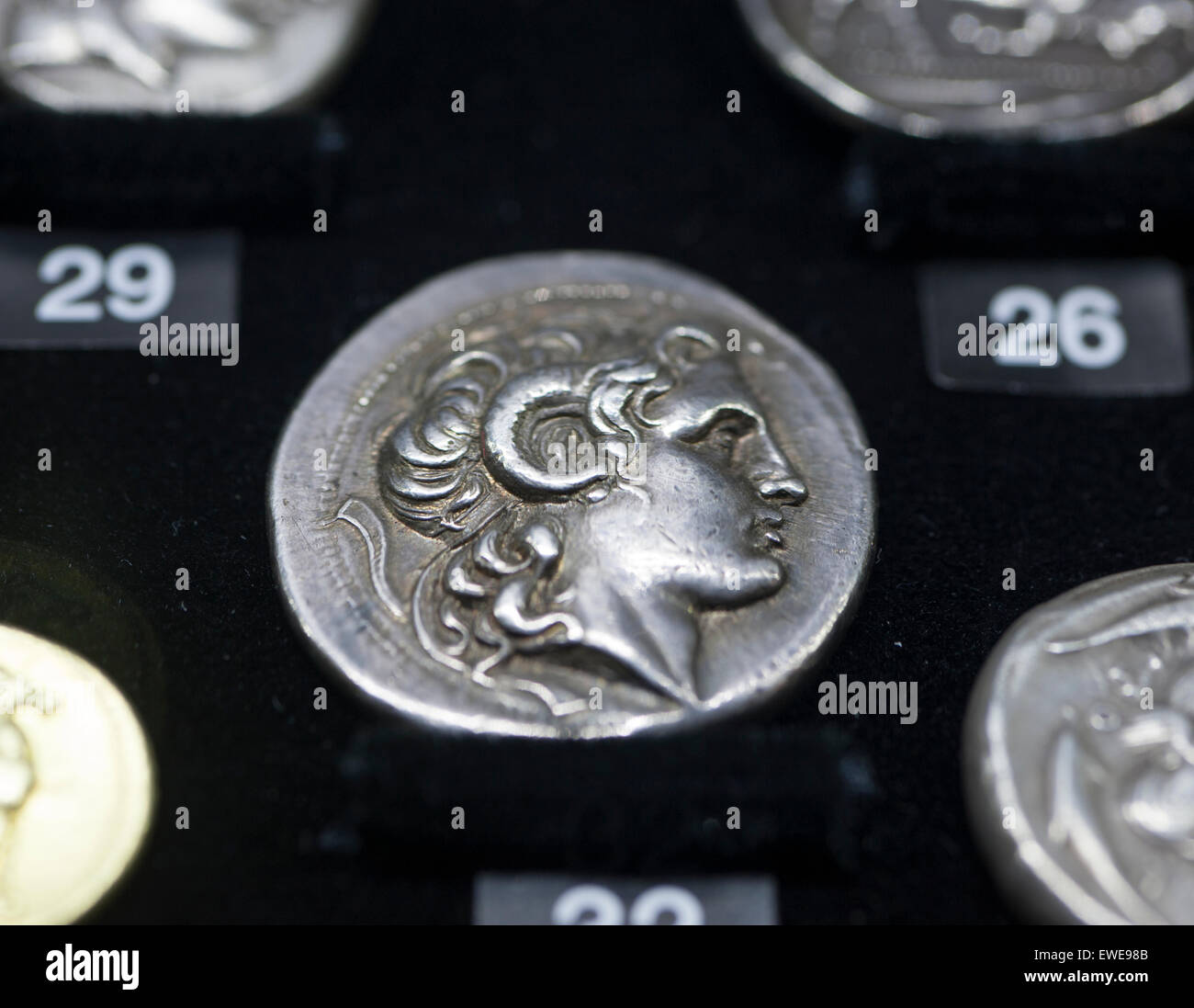 Royal Hospital Chelsea, London UK. 24th June 2015. Masterpiece 2015, the summer’s leading international art, antiques and design fair, opens from 25th June till 1st July. Rare Alexander the Great coin on the Baldwin’s Stanley Gibbons stand. Credit:  Malcolm Park editorial/Alamy Live News Stock Photo