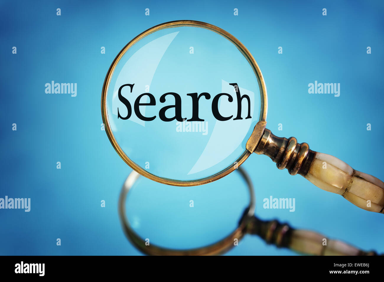 Magnifying glass focus on the word search Stock Photo