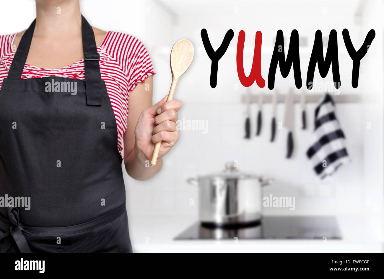 yummy cook holding wooden spoon background. Stock Photo
