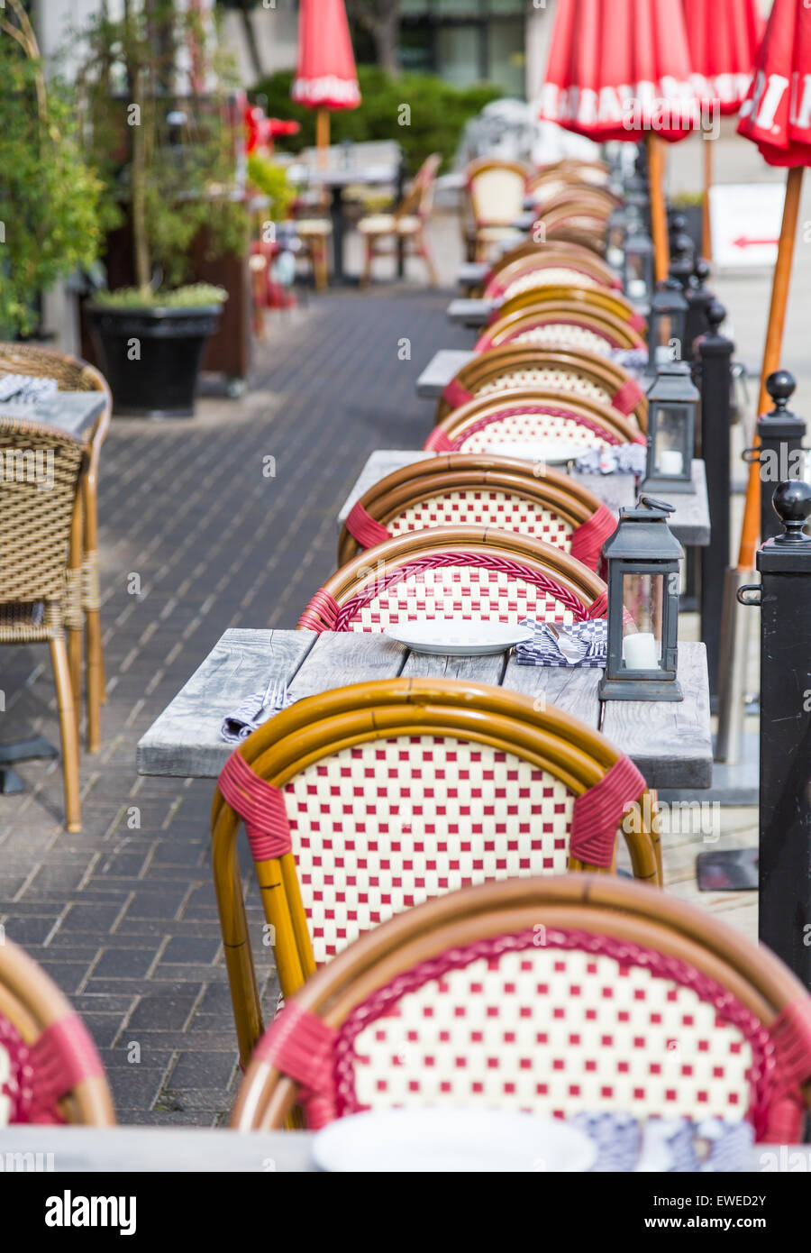 Wicker chairs and wood tables at an outdoor restaurant patio Stock ...