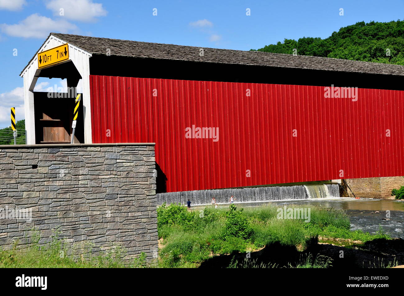 Asheville, Pennsylvania:  1884 vernacular Burr arch-truss wooden covered bridge over the Octoraro Creek Stock Photo