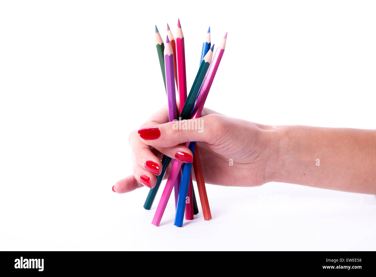 Woman hand with red manicure holding colorful pencils Stock Photo