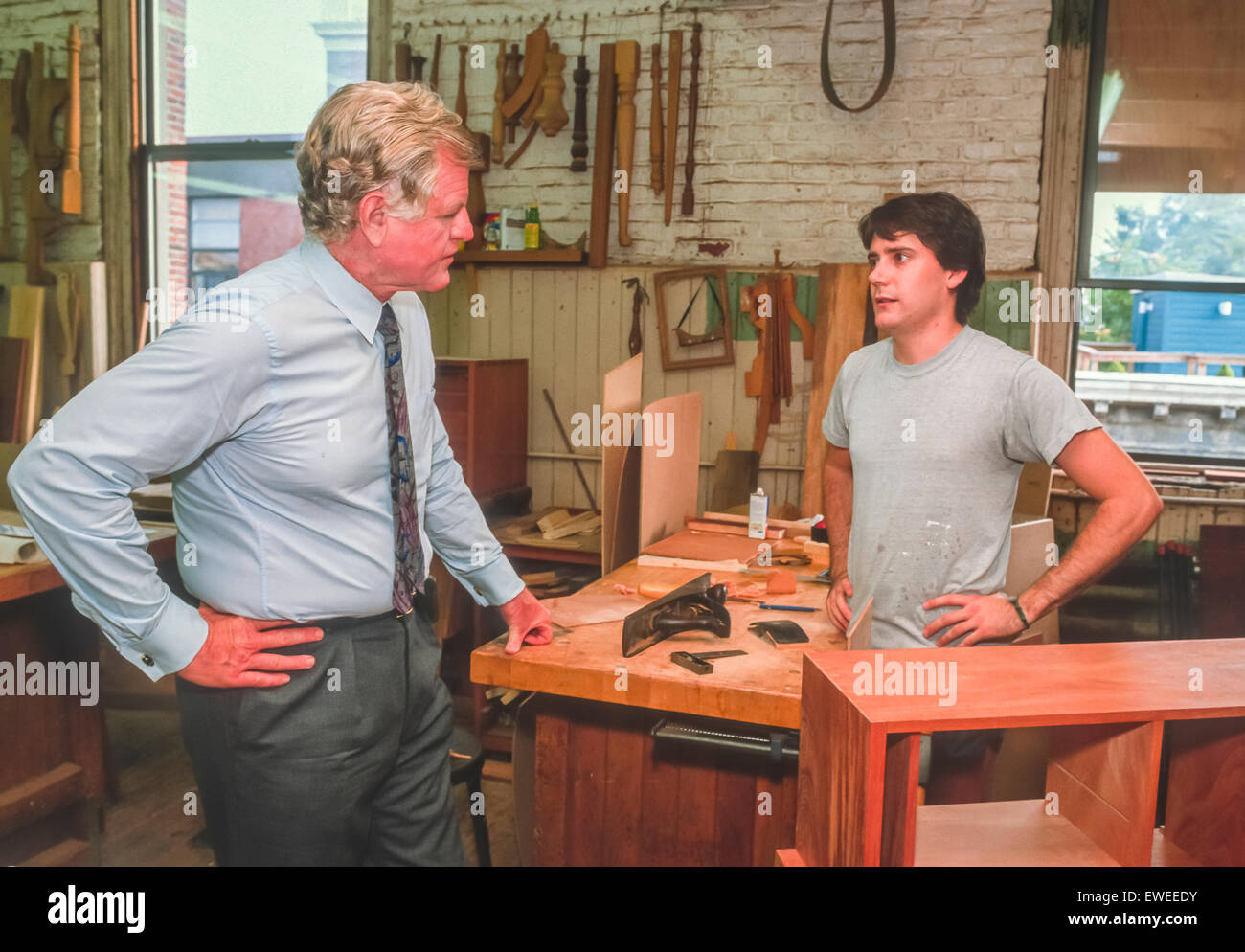 BOSTON, MASSACHUSETTS, USA - U. S. Senator Ted Kennedy (D-MA), left, tours wood shop in vocational school. November 1989 Stock Photo