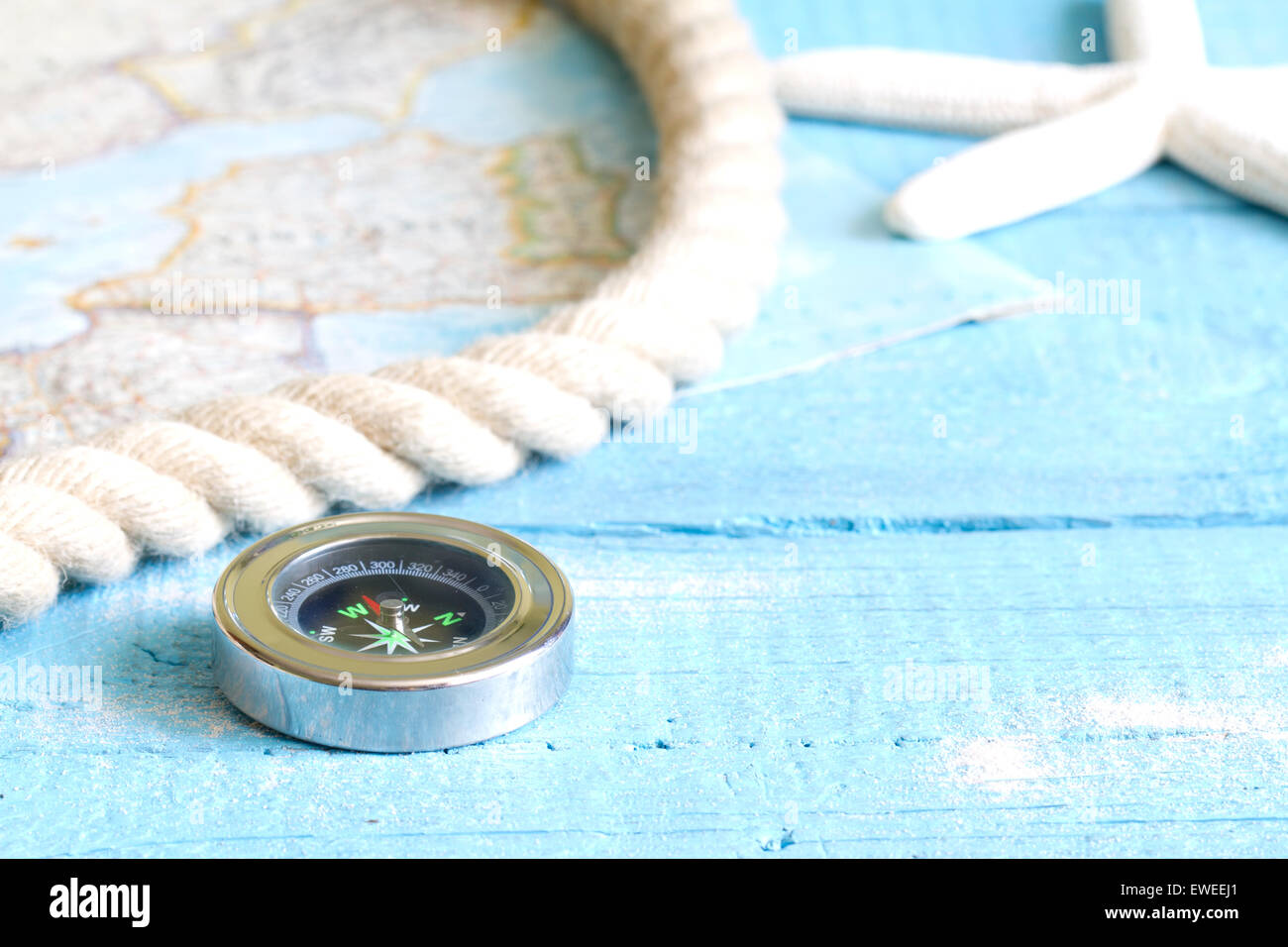 Compass and rope on blue boards travel concept Stock Photo