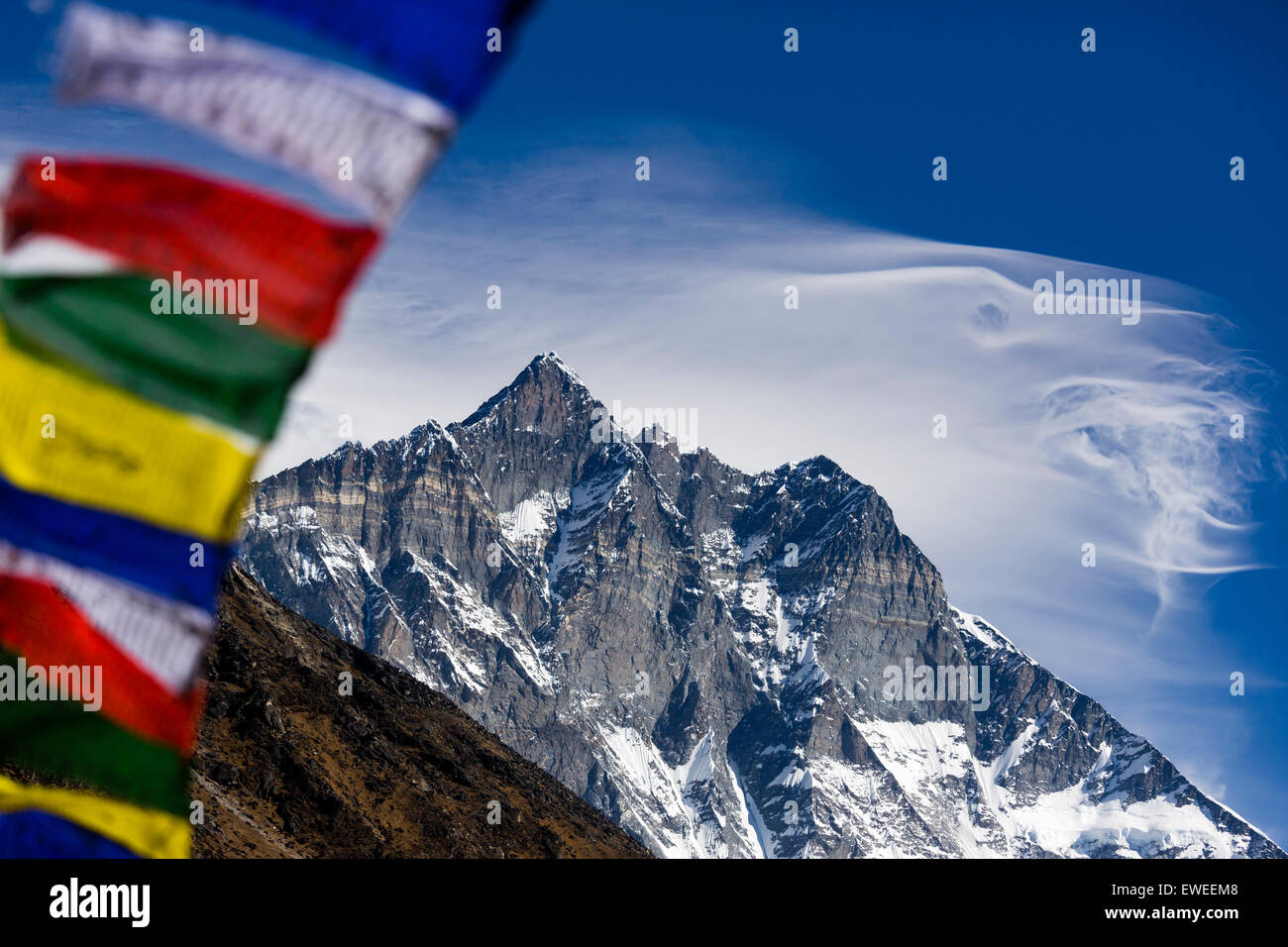 Prayer flags with Lhotse Shar (8386m) in the distance, Sagarmatha National Park, Khumbu region, Nepal. Stock Photo