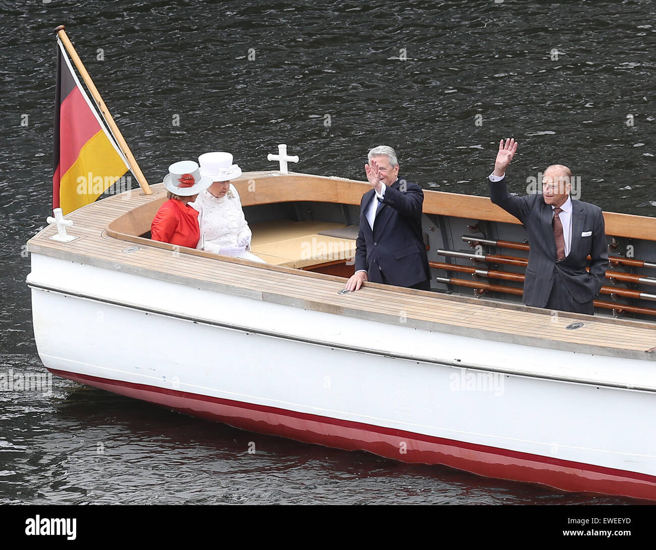 Berlin, Germany. 24th June, 2015. British Queen Elizabeth II. and Prince Philip (R), Duke of Edinburgh, accompanied by German President Joachim Gauck (2-R) and his partner Daniela Schadt (wearing red) ride along the Spree river during a boat tour in Berlin, Germany, 24 June 2015. The British Queen and her husband are on their fifth state visit to Germany. PHOTO: Wolfgang Kumm/dpa/Alamy Live News Stock Photo