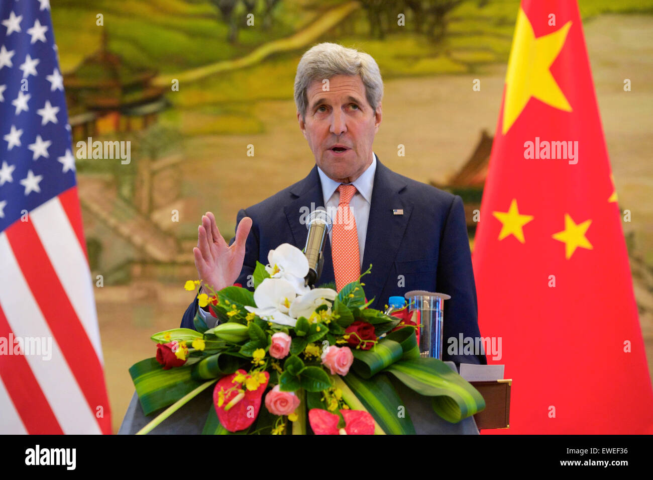 U.S. Secretary of State John Kerry addresses reporters as Chinese Foreign Minister Wang Yi listens at the Ministry of Foreign Affairs in Beijing, China, following a bilateral meeting on May 16, 2015. Stock Photo
