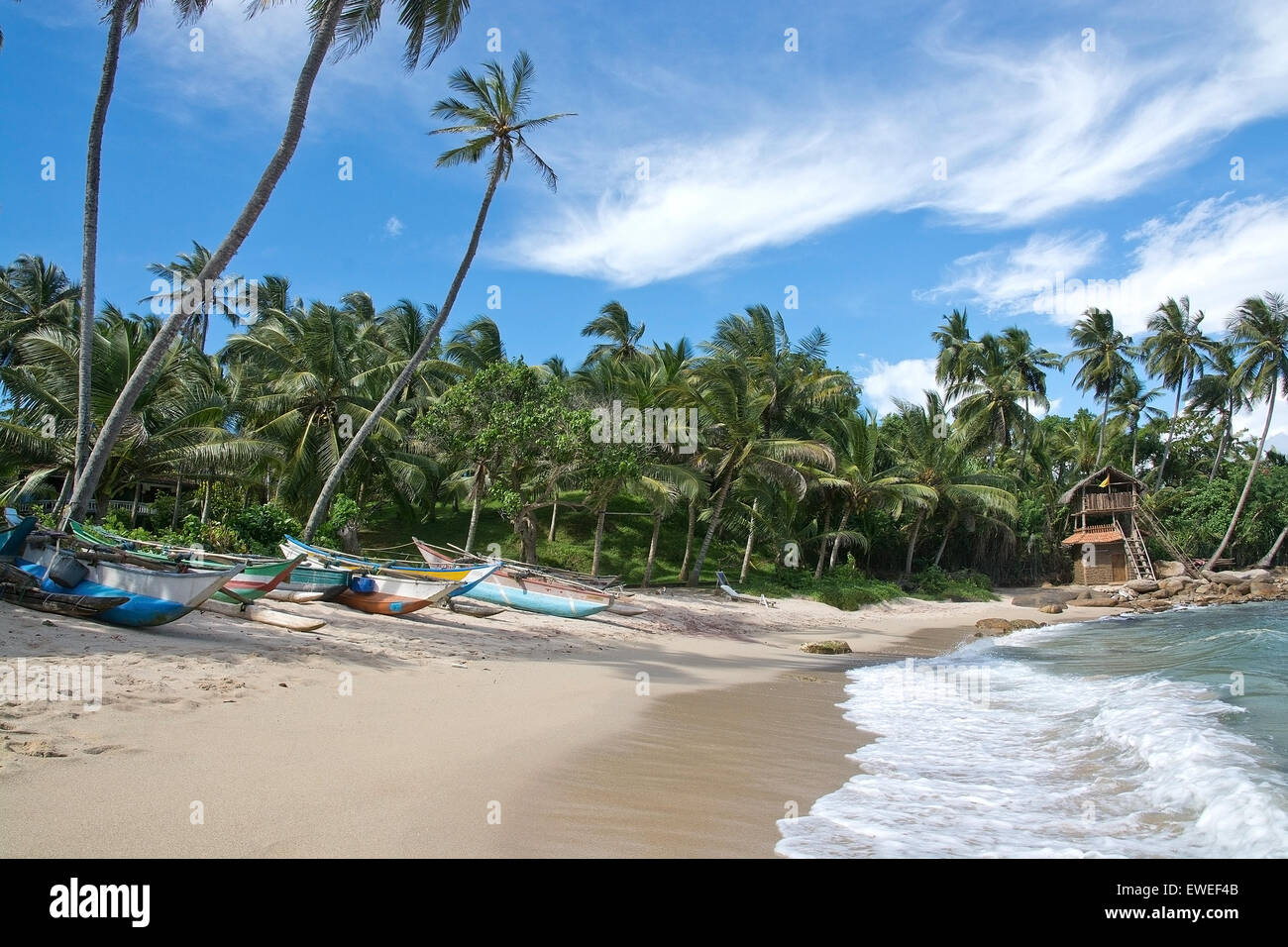 Sea food restaurant Think Club built by wooden sticks and buffalo dung and boats on the Rocky Point beach. Stock Photo