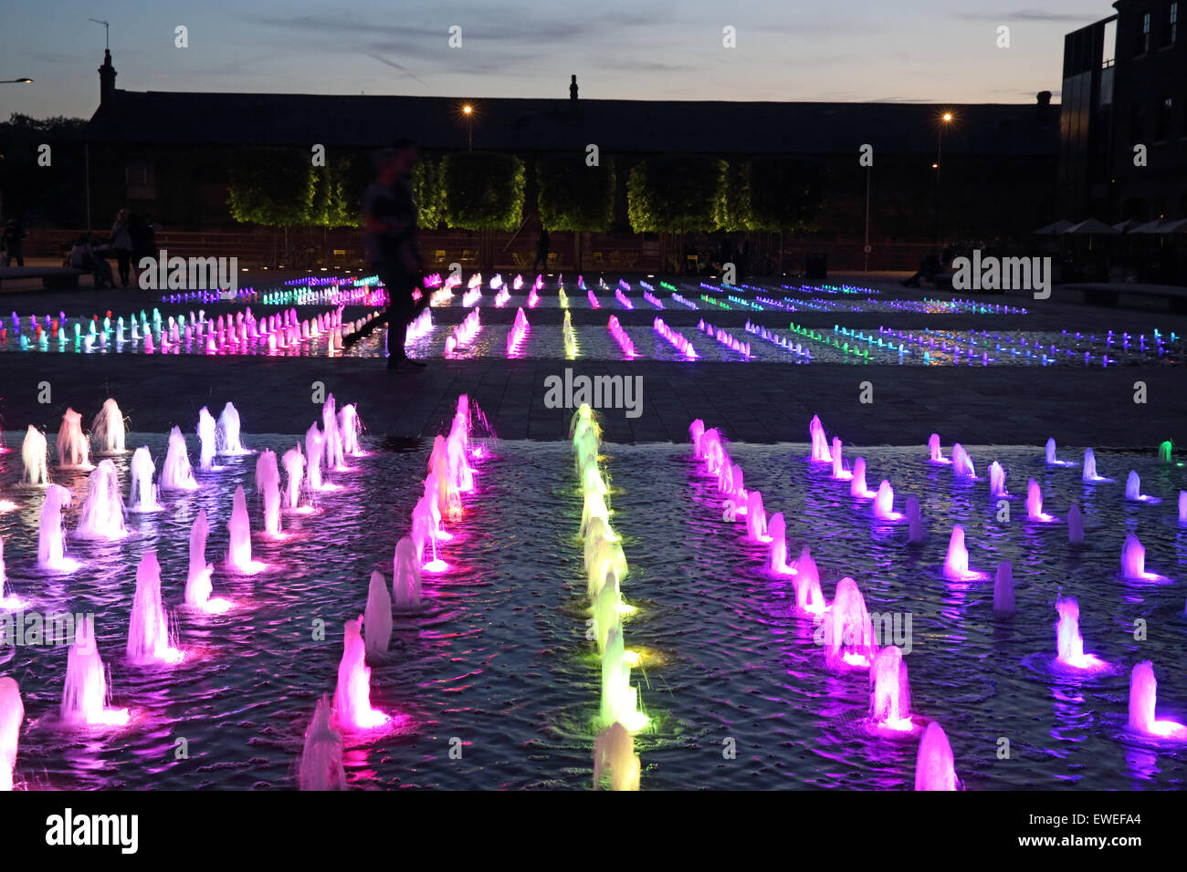 The coloured fountains in Granary Square at night, behind King's Cross