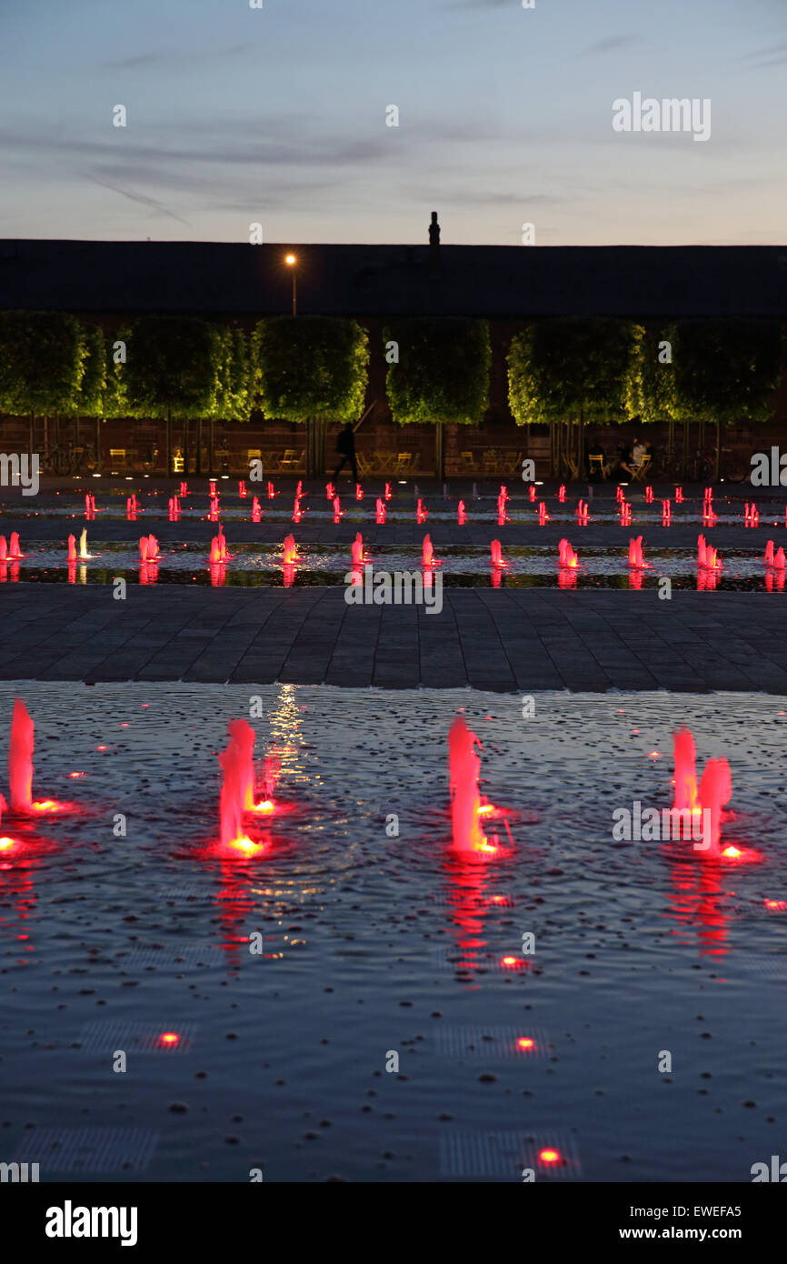 The coloured fountains in Granary Square at night, behind King's Cross
