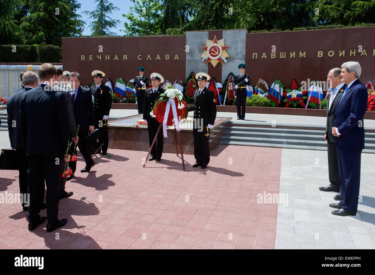 U.S. Secretary of State John Kerry and Russian Foreign Minister Sergey Lavrov watch as members of their respective staffs each place a pair of roses on May 12, 2015, at the Zavokzalny War Memorial in Sochi, Russia, built in 1985 to commemorate the 40th anniversary of the end of World War II, and where about 4,000 soldiers are buried. Stock Photo