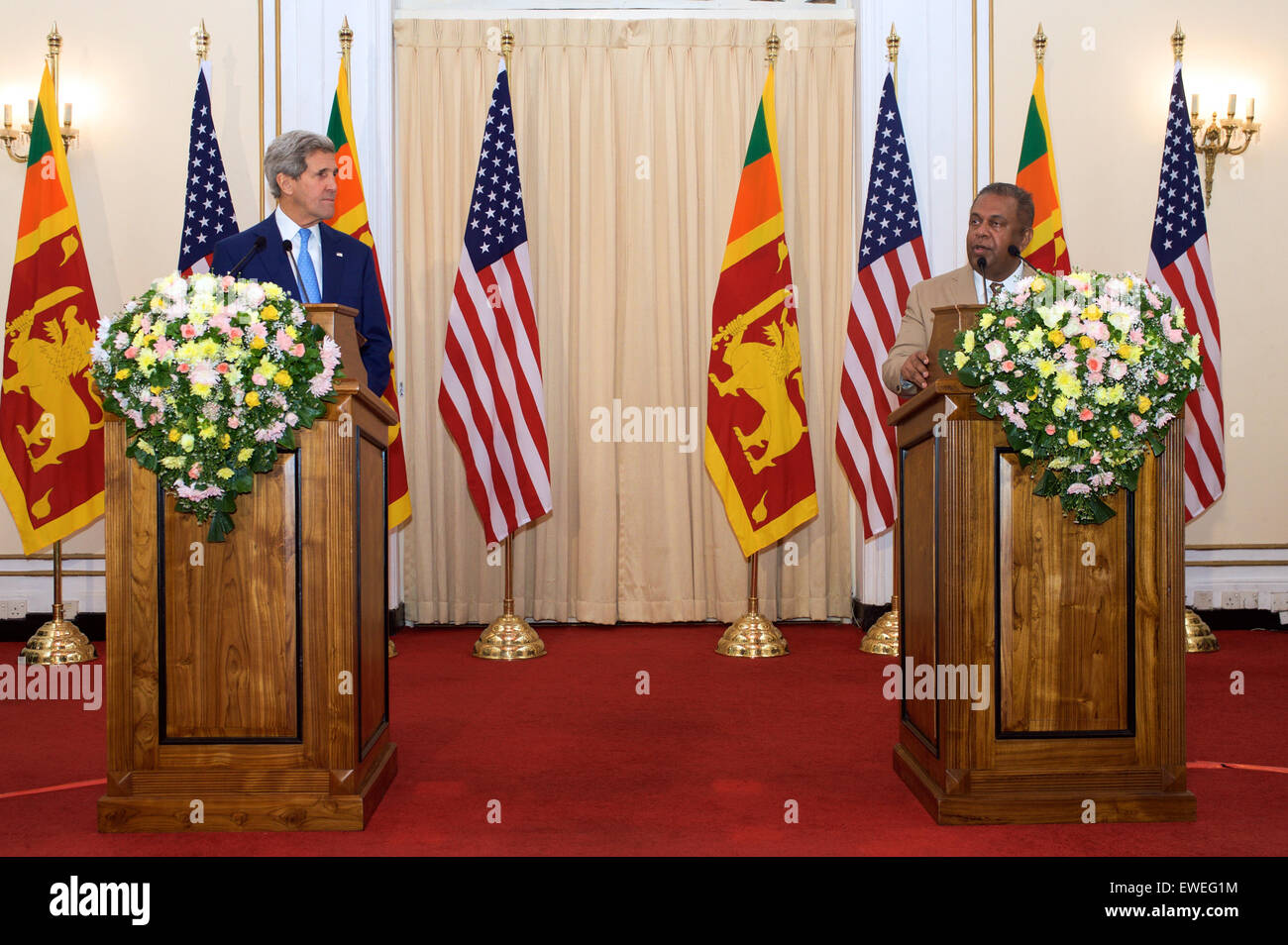 U.S. Secretary of State John Kerry listens as Sri Lankan Foreign Minister Mangala Samaraweera makes a statement to reporters assembled at the Ministry of Foreign Affairs in Colombo, Sri Lanka, on May 2, 2015, before the Secretary with President Maithripala Sirisena and Prime Minister Ranil Wickremesinghe. Stock Photo
