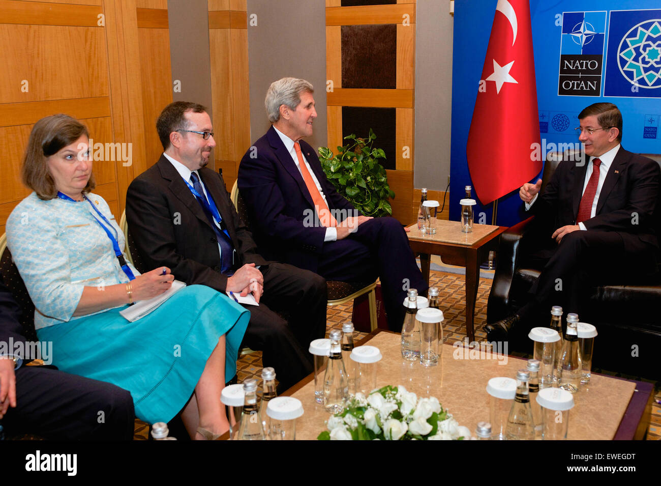 U.S. Secretary of State John Kerry, flanked by U.S. Ambassador to Turkey John Bass and U.S. Assistant Secretary of State for European and Eurasian Affairs Toria Nuland, meets with Turkish Prime Minister Ahmet Davutoglu - his former counterpart as Foreign Minister - on the sidelines of a NATO Ministerial Meeting in Antalya, Turkey, on May 13, 2015. Stock Photo