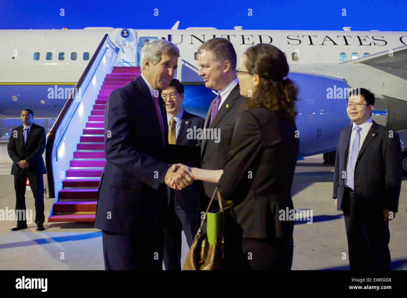 U.S. Secretary of State John Kerry shakes hands with Acting U.S. Embassy Beijing Deputy Chief of Mission Kaye Lee while being introduced by Charge d'Affaires Dan Kritenbrink after stepping off his plane in Beijing, China, in the pre-dawn hours of May 16, 2015, for meetings with President Xi Jinping, Premier Li Keqiang, Foreign Minister Wang Yi, State Councilor Yang Jiechi, Vice Chair Of Central Military Commission Fan Changlong, and other government leaders. Stock Photo