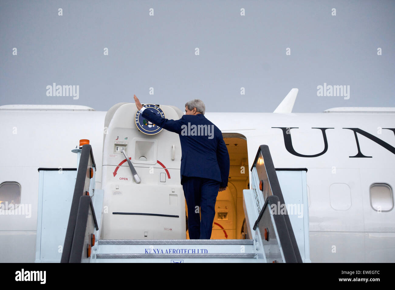 U.S. Secretary of State John Kerry waves goodbye to a group of ...