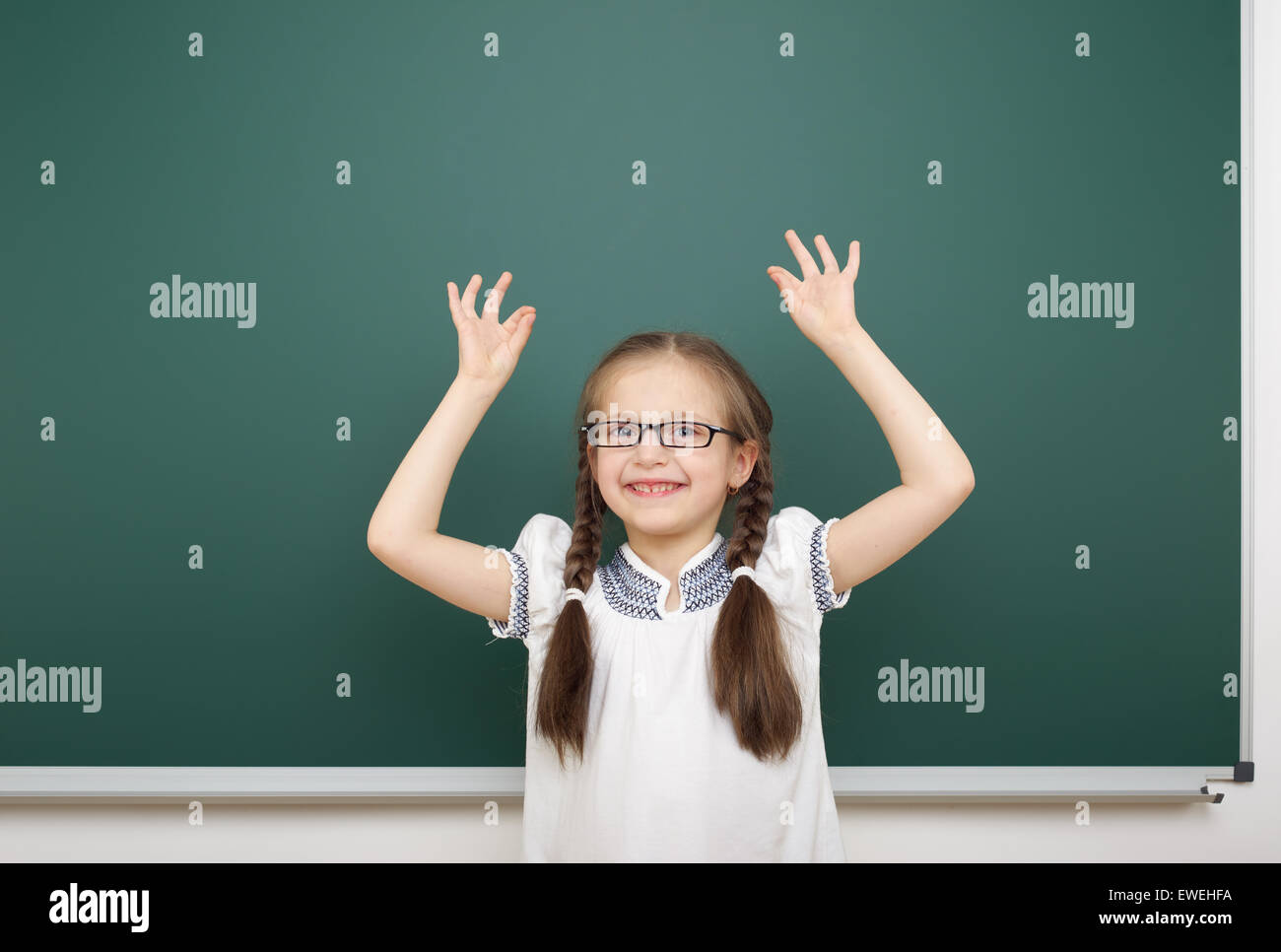 Schoolgirl near the school board Stock Photo - Alamy