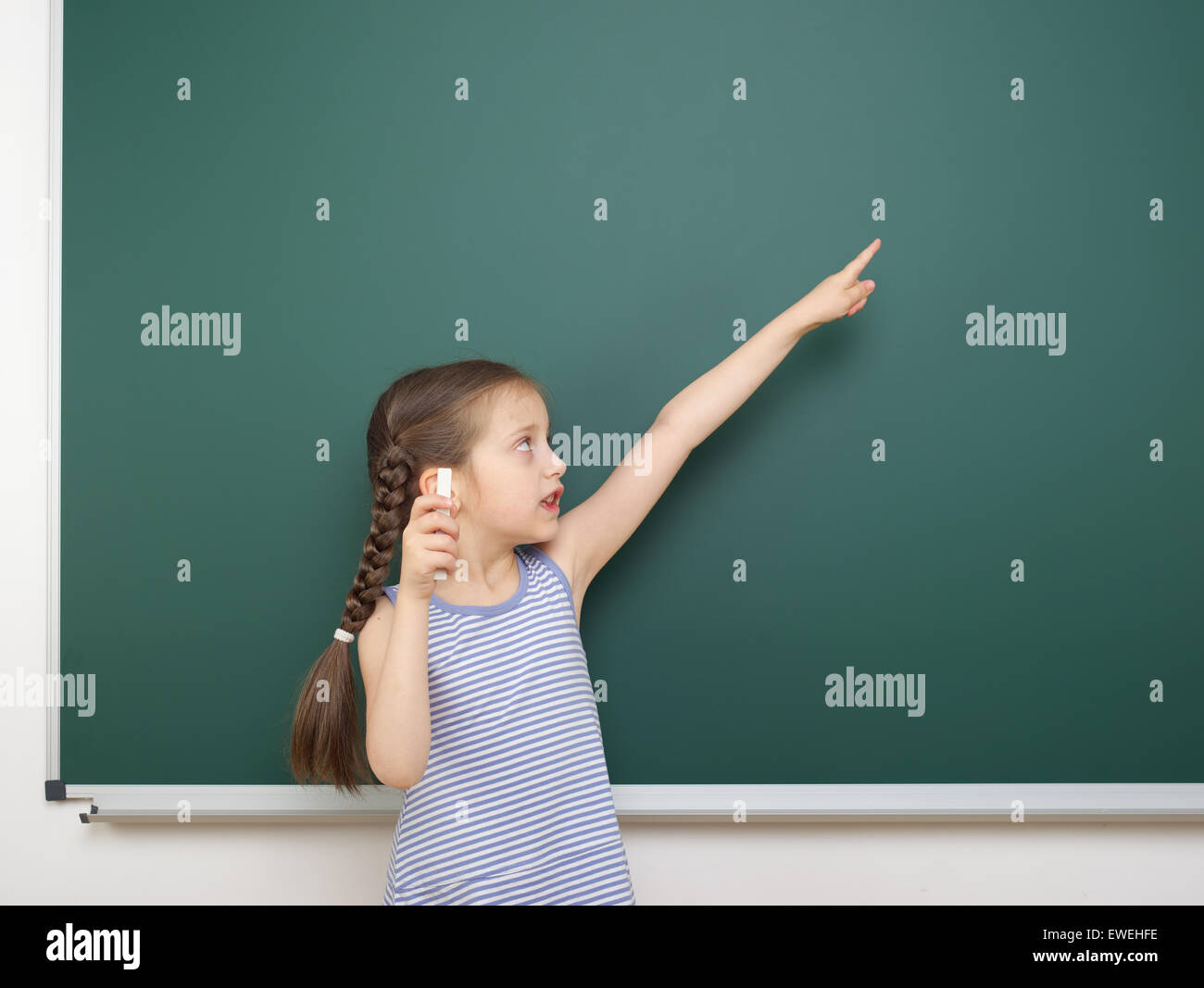 Schoolgirl near the school board Stock Photo - Alamy