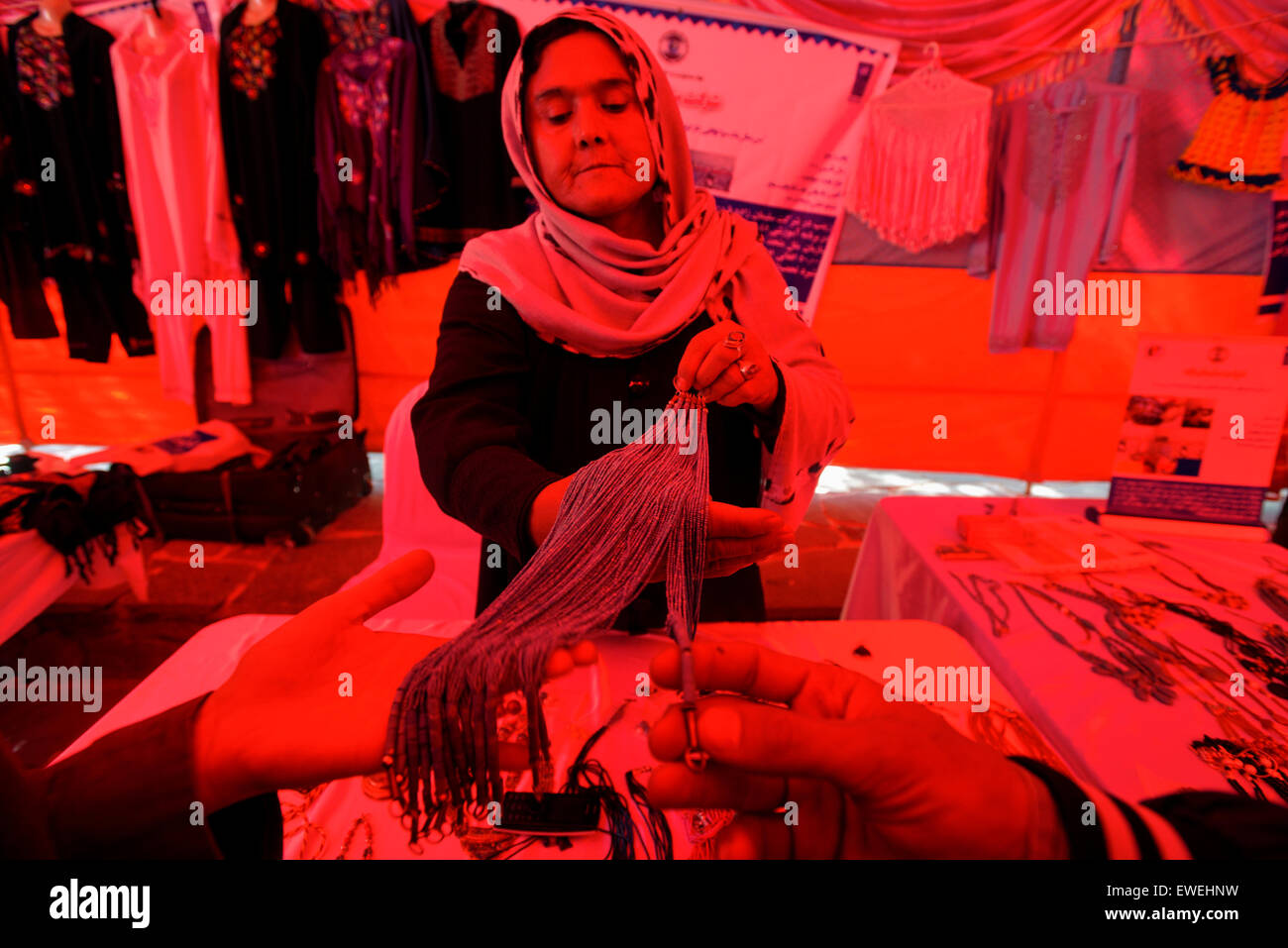 Woman selling traditional Afghan jewelry at exhibition dedicated to