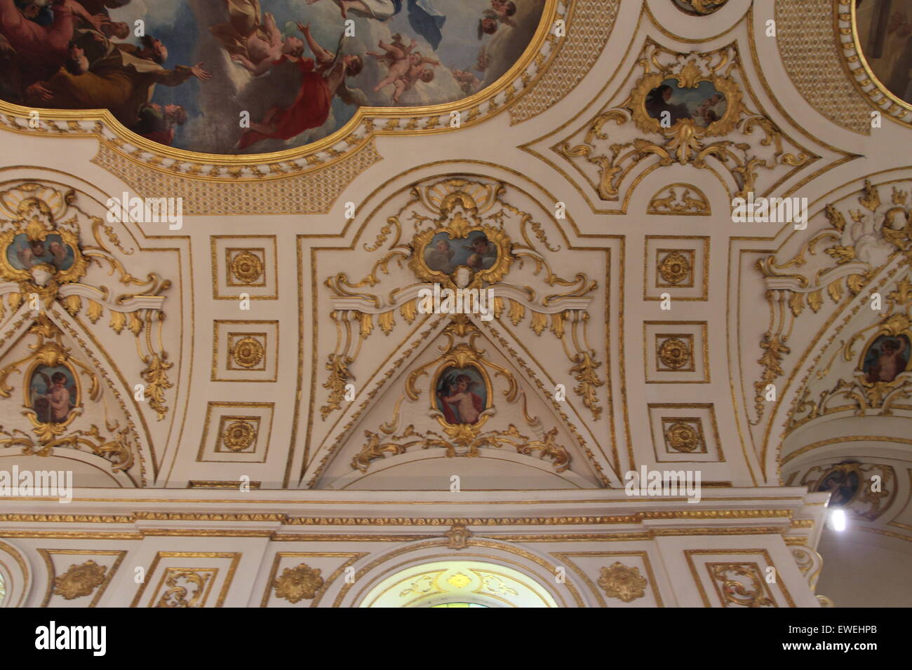 Church Organ gold pipes and Artwork religious painting of the ceiling of the church Stock Photo